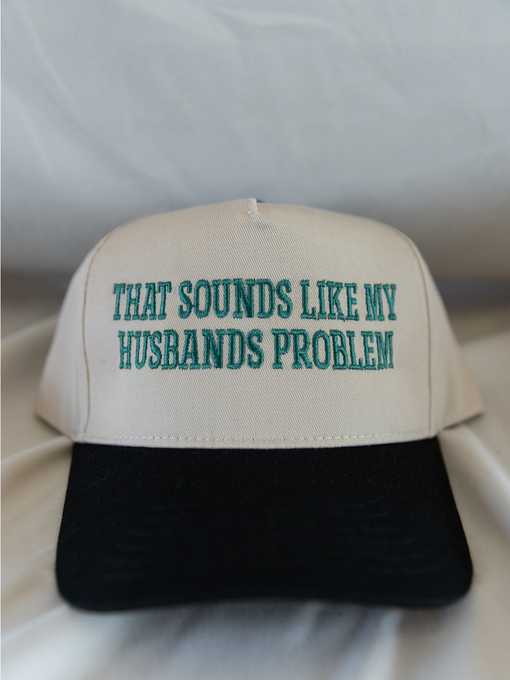 Cream and Black Baseball Cap with Teal Slogan